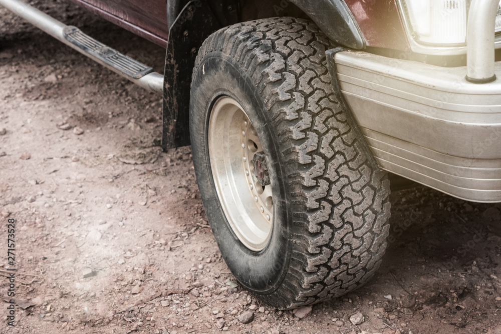 Close up dirty off-road car wheel.