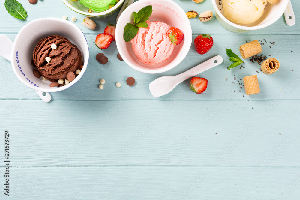 Homemade assorted ice cream on light blue wooden background. Healthy summer food concept. Top view, copy space. Homemade assorted ice cream on light blue wooden background. Healthy summer food concept. Top view, copy space.
