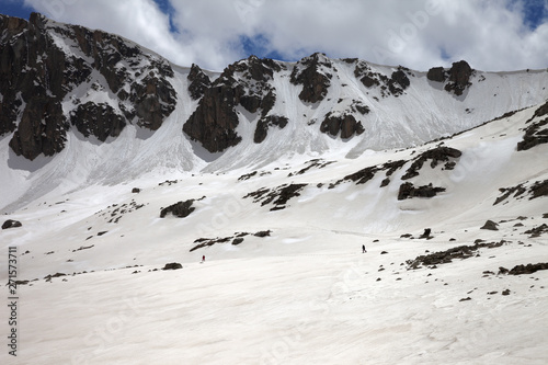 High mountains with snow cornice and avalanche trail photo