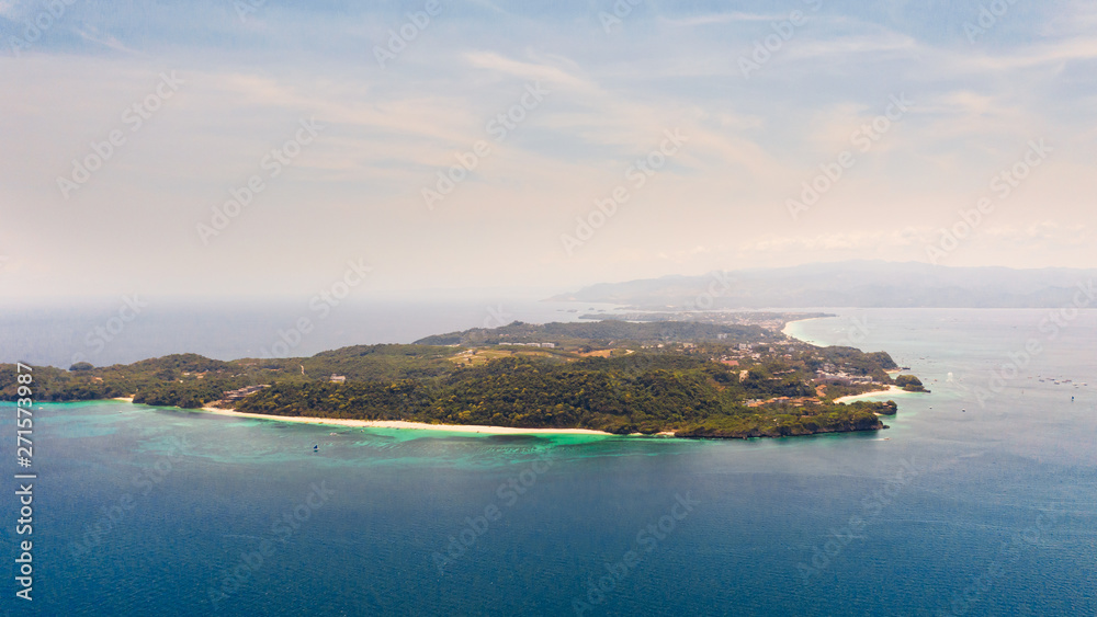 Seascape with island of Boracay, Philippines, top view. A large island with urban buildings and white beaches.