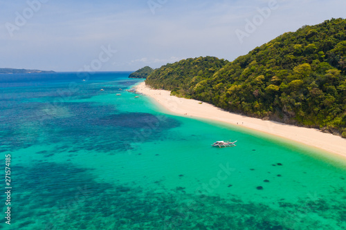 Fototapeta Naklejka Na Ścianę i Meble -  Puka Shell Beach. Wide tropical beach with white sand. Beautiful white beach and azure water on Boracay island, Philippines, top view. Tourists relax on the beach.