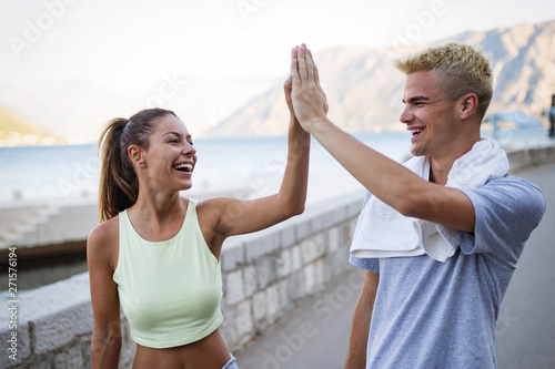 Happy young fit people couple running outdoor