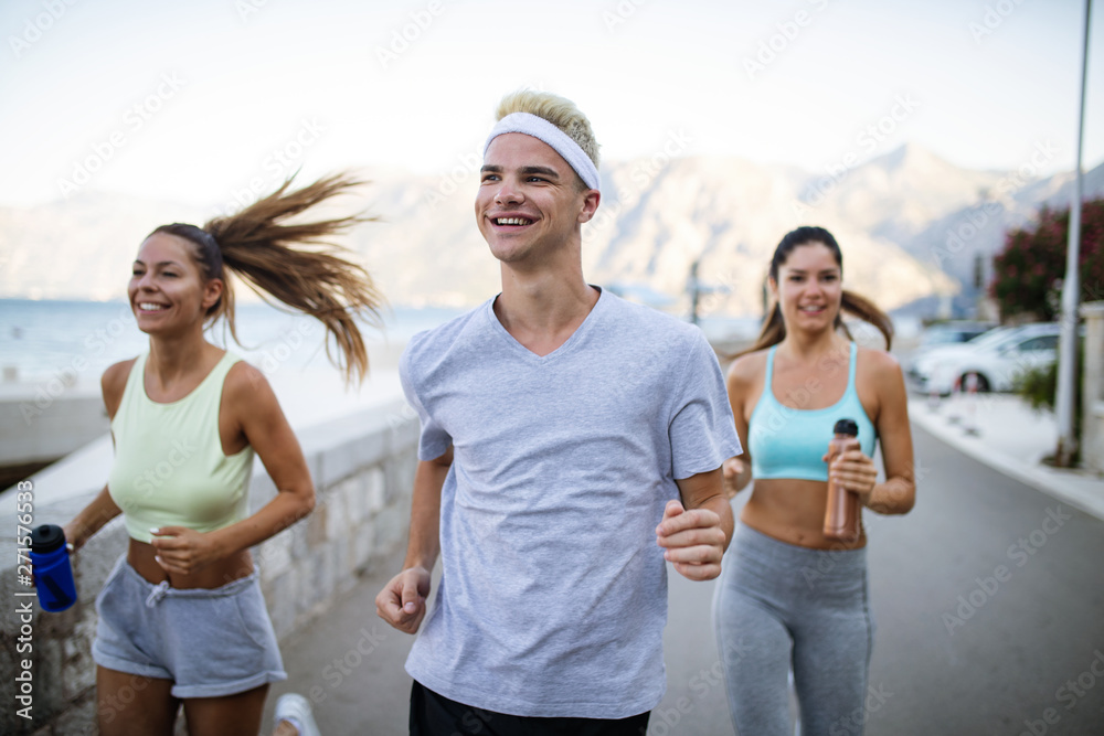 Group of young people friends running outdoors at seaside Group of young people friends running outdoors at seaside