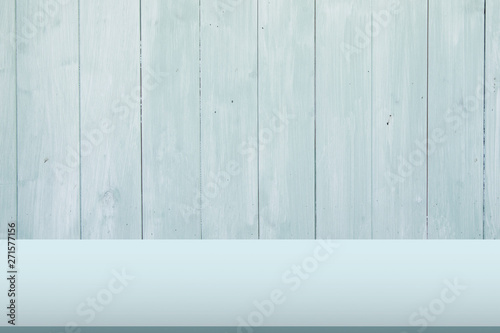 Light green wooden table with wood wall office background, copy space.
