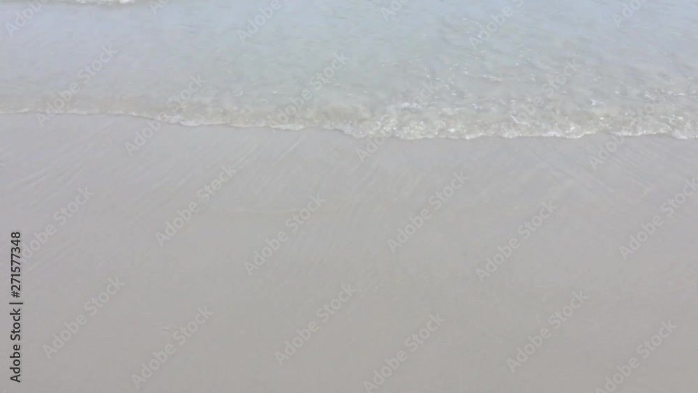 The sand beach with waves toward the shore, the concept of relaxation in the summer. The sand beach with waves toward the shore, the concept of relaxation in the summer.