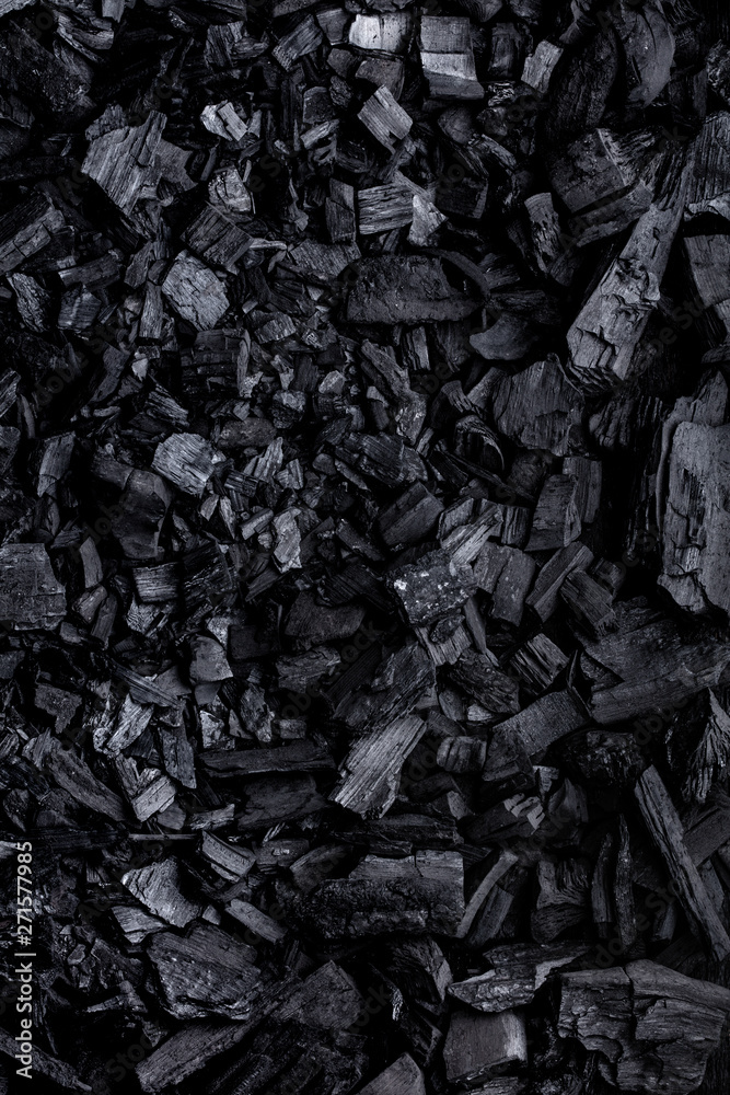 Flat lay of coal mineral black stones background. Coal pattern studio background