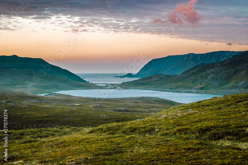 Nord summer Norwegian landscape behind the polar circle with green hills, sea bay, lake and camp village near North Cape (Nordkapp), Finnmark, Norway. photo