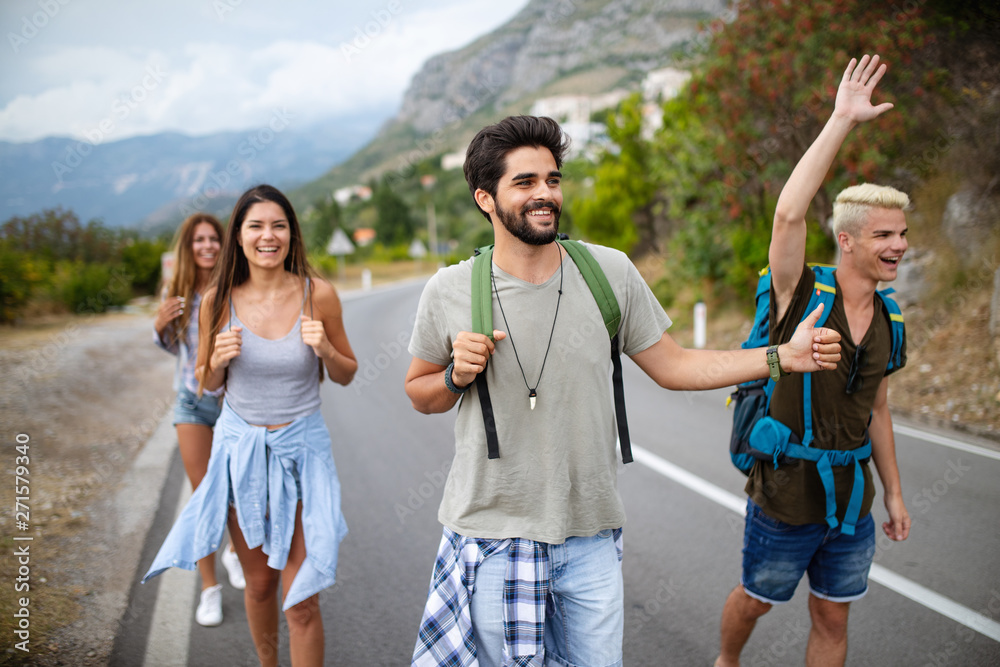 Group of backpackers and young friends traveling and having fun together Group of backpackers and young friends traveling and having fun together