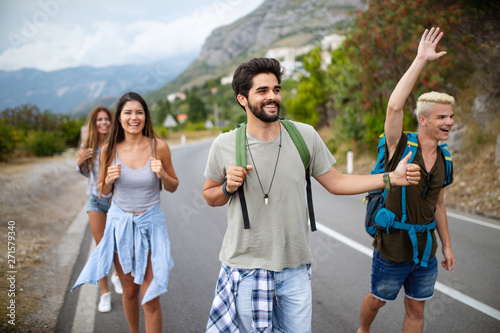 Group of backpackers and young friends traveling and having fun together
