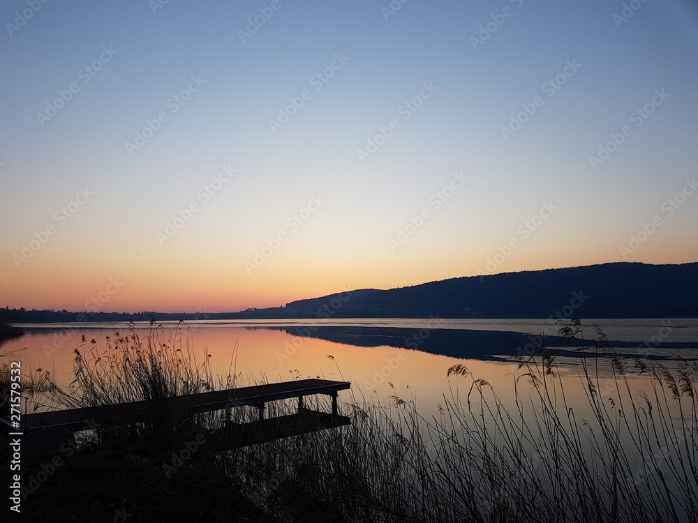 Corgeno lake, Italy - January 20, 2019: golden sunset on the Corgeno lake