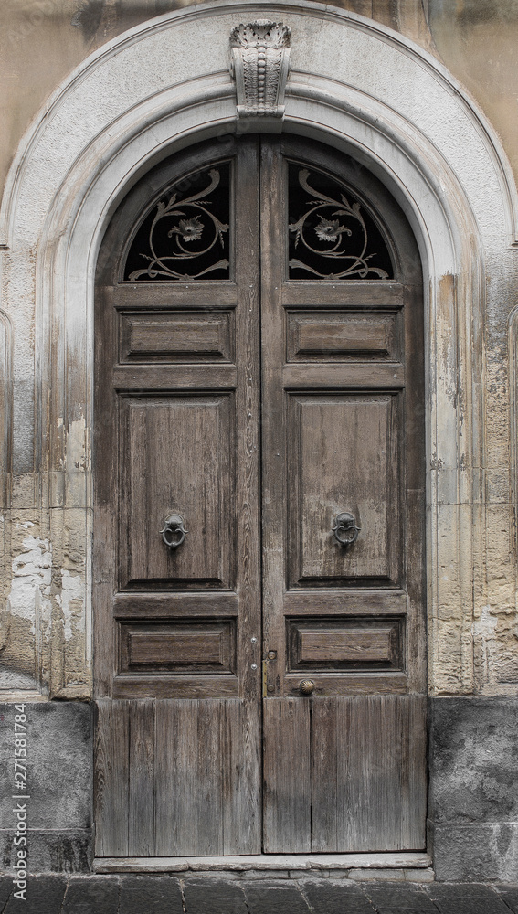 Ancient closed and forgotten doorway. old brown wooden door in Sicily.