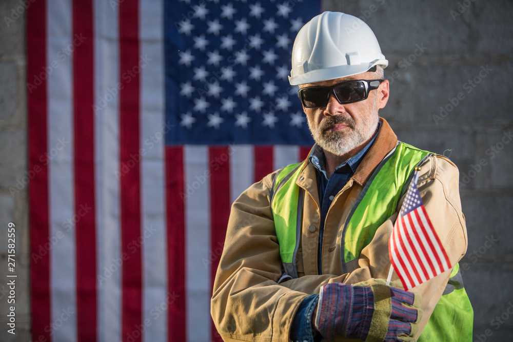 Fototapeta premium A serious worker man and american flag