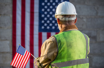 American builder with stars and stripes flag in background