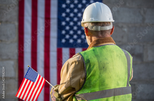American builder with stars and stripes flag in background