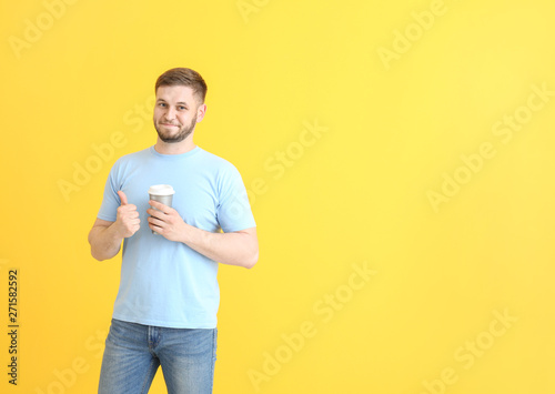 Handsome young man with cup...