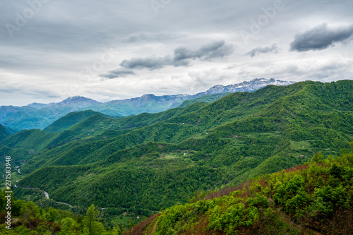 Montenegro, Magical green mountainous nature landscape from above with snow covered mountains at horizon near kolasin
