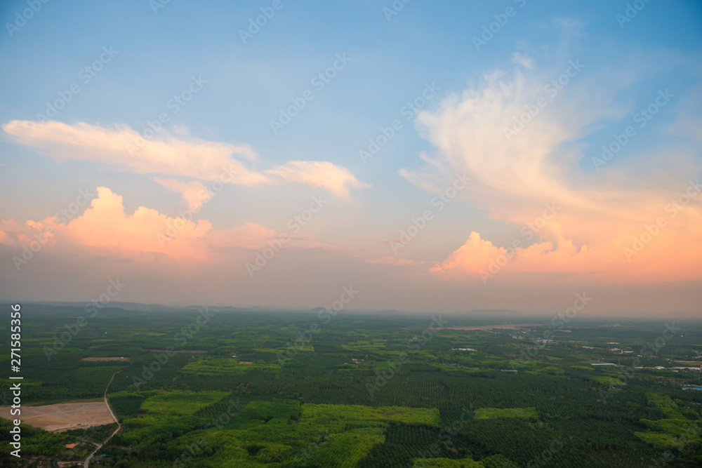 Fototapeta premium Top view of southeast asia countryside landscape with green fields and villages at sunset