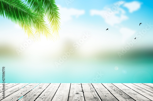 World Oceans Day concept: Empty wooden board on Palm leaves and Abstract blurred  beach with  sunset sky background photo