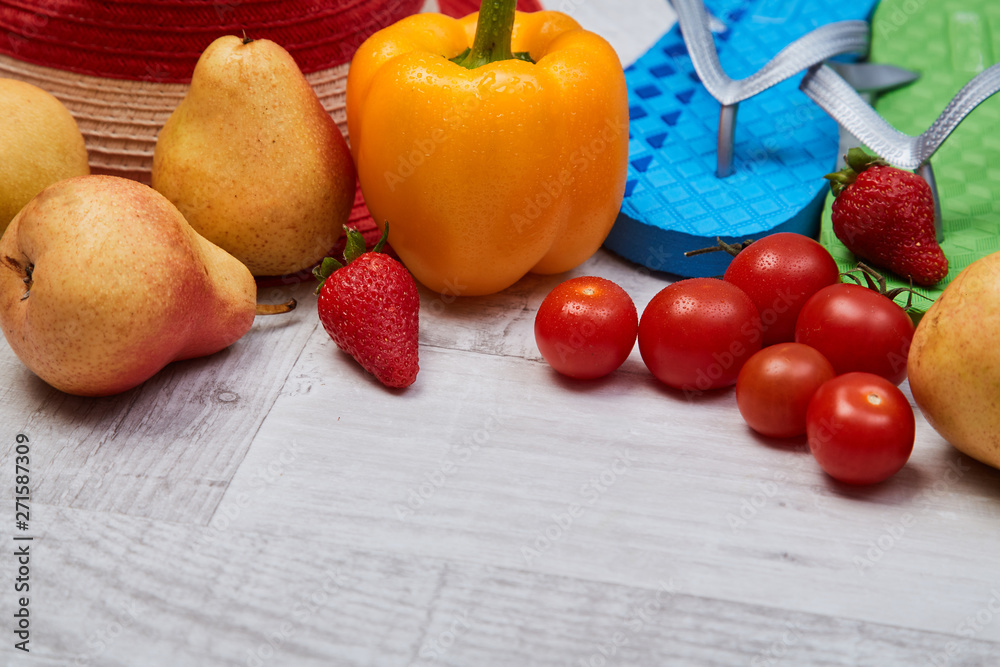 Composition of seasonal vegetables and fruits beside summer accessories. Close up. Food blogging concept Composition of seasonal vegetables and fruits beside summer accessories. Close up. Food blogging concept