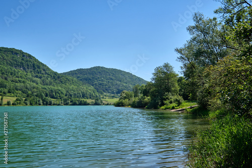 The beautiful lake called  "Happurger See" (also "Happurger Stausee") in the Hersbruck Switzerland with the mountain called "Houbirg" in the background on a perfect sunny summer day with blue sky © franconiaphoto