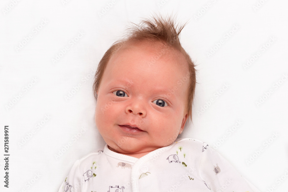 Cute Smiling newborn baby boy. Adorable infant looking at camera. Cute Smiling newborn baby boy. Adorable infant looking at camera.