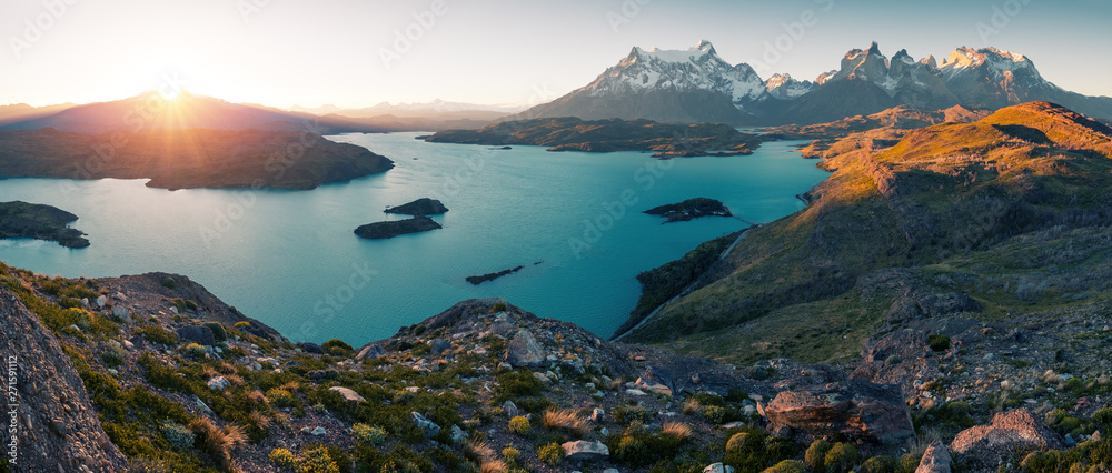 Panorama of Torres del Paine National Park with snow capped mountains (Cordillera Paine) and blue lake of Pehoe as seen from the Mirador Condor during sunset. Chile