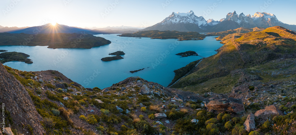 Panorama of Torres del Paine National Park with snow capped mountains (Cordillera Paine) and blue lake of Pehoe as seen from the Mirador Condor during sunset. Chilean Patagonia