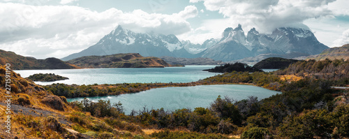 Torres del Paine National Park with snow capped mountains (Cordillera Paine) and the lake of Pehoe during sunny and windy weather. Chile
