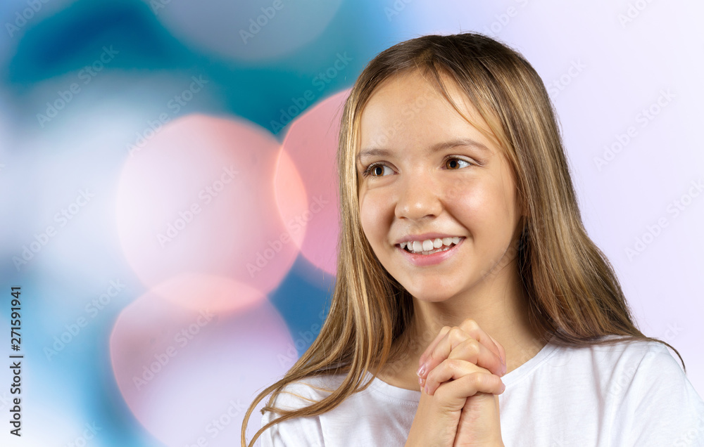Little girl with blue eyes and blonde hair smiling, looking in camera