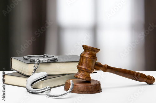 Wooden judge gavel on table, front close-up view