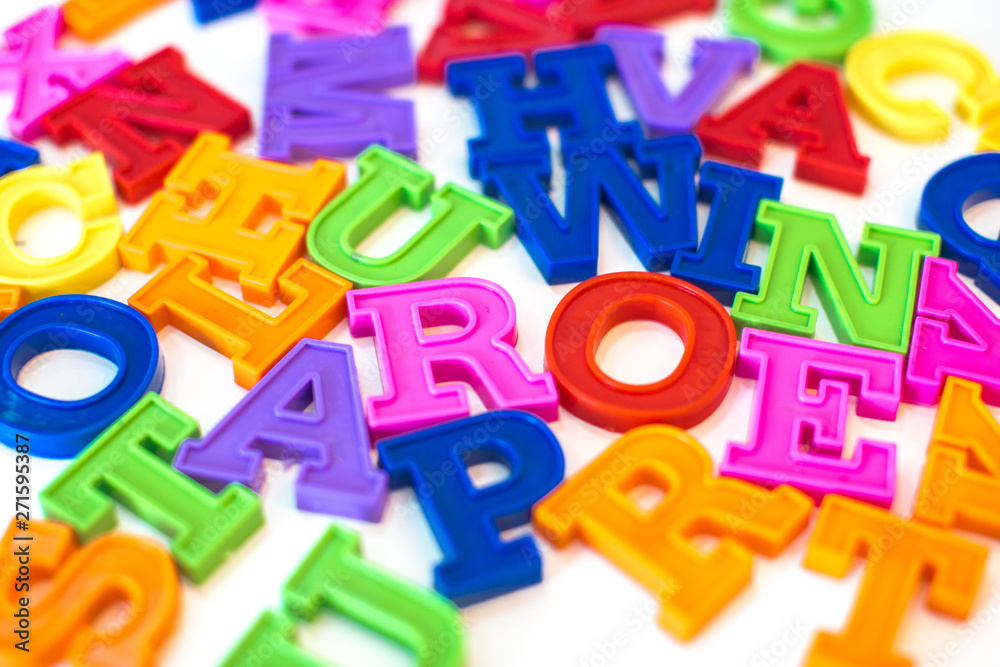 Heap of plastic colored alphabet letters close up. Heap of plastic colored alphabet letters close up.