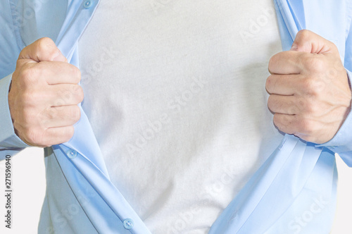 Man hands pulling open shirt showing white  t shirt
