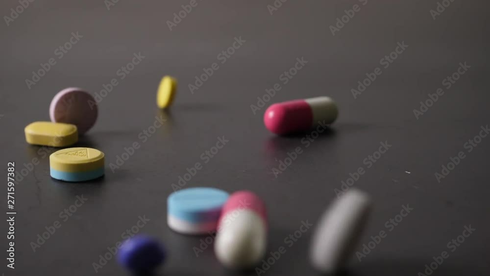 Slow motion of Pills falling on table Slow motion of Pills falling on table