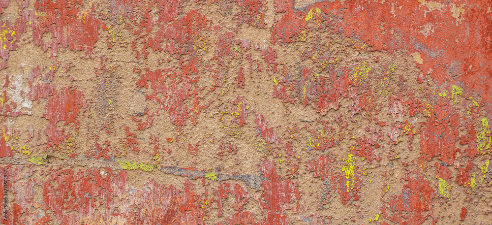 Old cracked weathered shabby red yellow painted plastered peeled wall banner background.