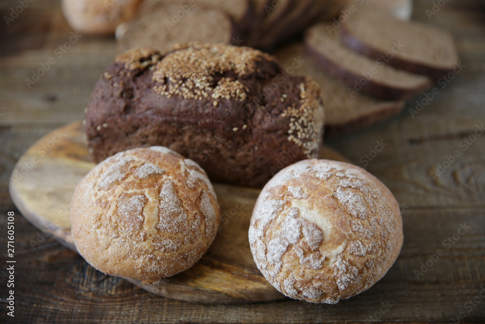  assortment of wheat and rye bread, close-up on a wooden rustic background