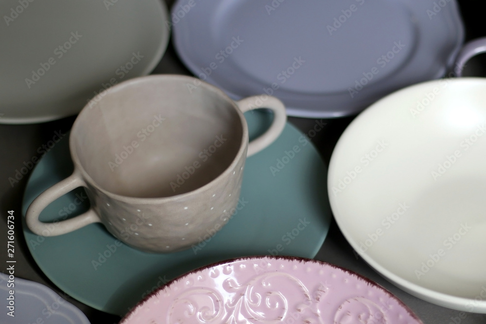 Collection of pottery and kitchenware in muted pastel colors. Selective focus. Collection of pottery and kitchenware in muted pastel colors. Selective focus.
