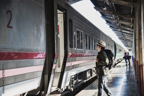 Travel man wait train at platform - people vacation lifestyle activities at train station transportation concept