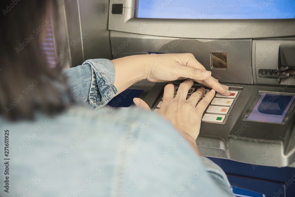 People waiting to get money from automated teller machine - people withdrawn money from ATM concept People waiting to get money from automated teller machine - people withdrawn money from ATM concept