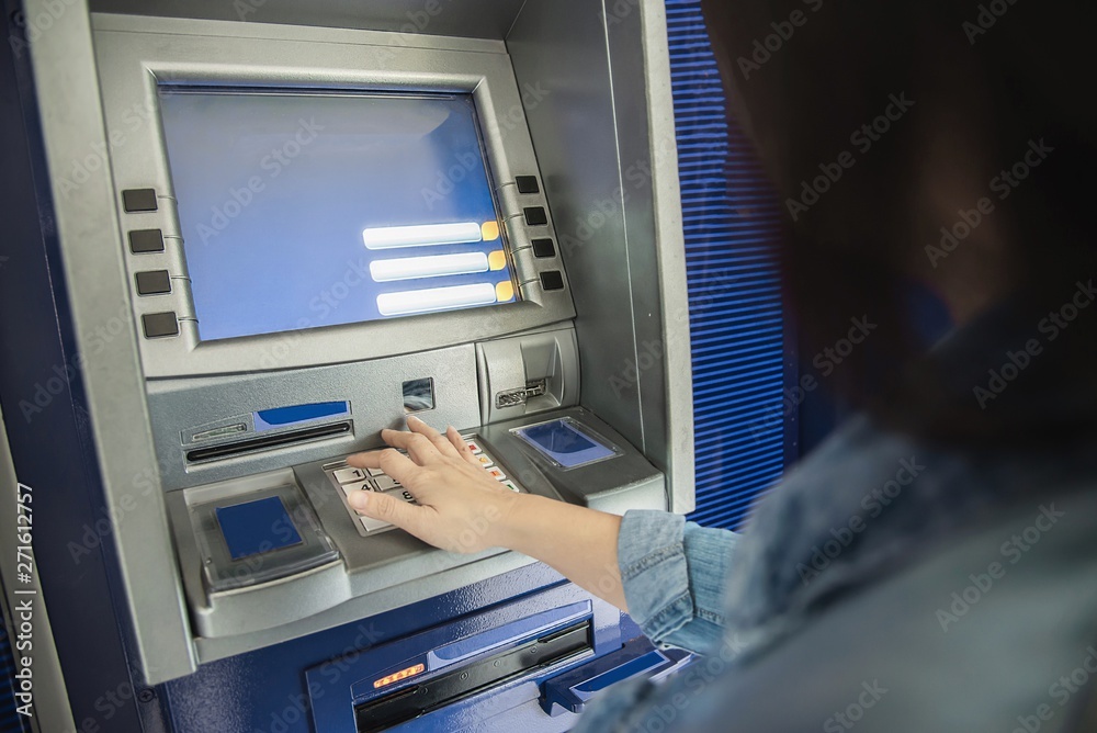 People waiting to get money from automated teller machine - people withdrawn money from ATM concept People waiting to get money from automated teller machine - people withdrawn money from ATM concept