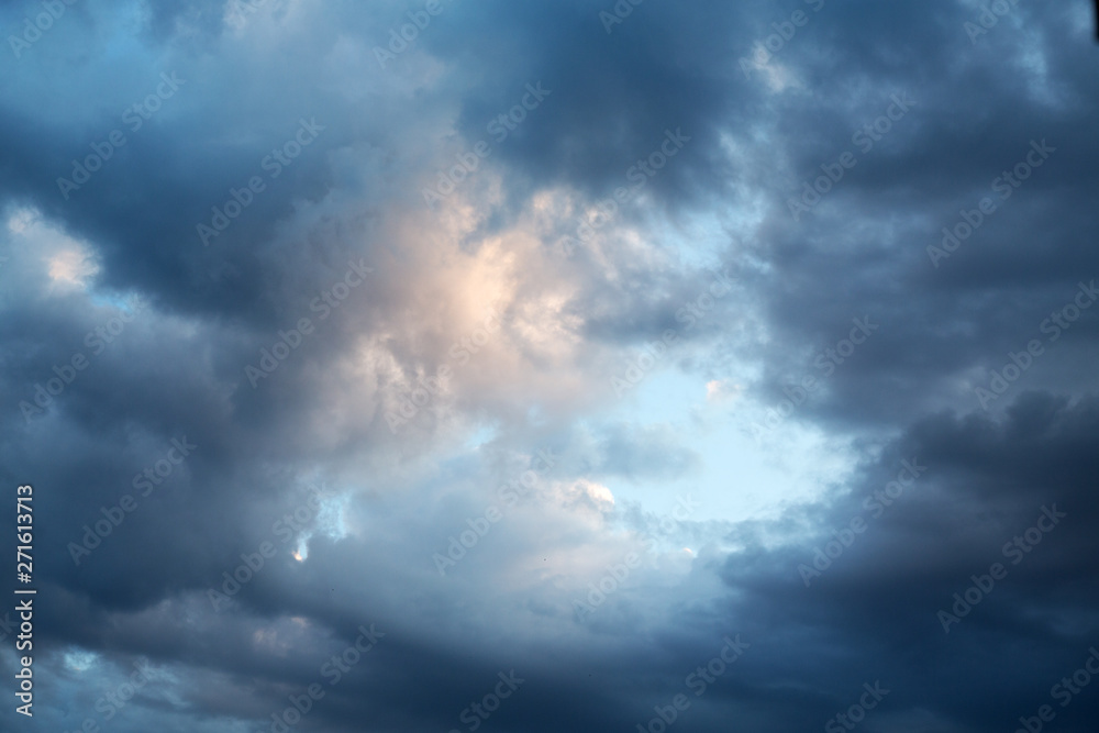 dark evening cumulus clouds in the setting sun dark evening cumulus clouds in the setting sun