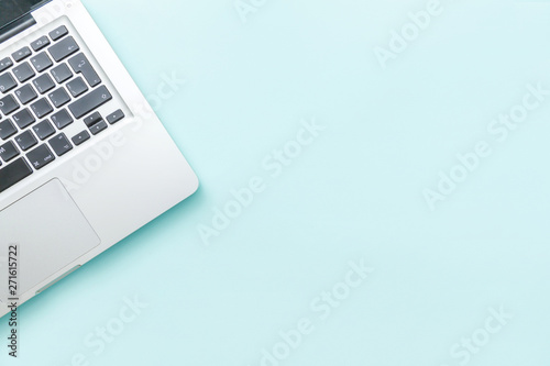 Keyboard laptop computer isolated on blue pastel desk background. Modern Information technology and sofware advances. Freelance home office programmer or designer workspace concept
