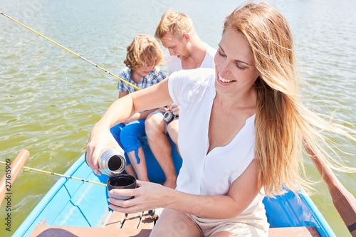 Happy family while fishing on a lake © Robert Kneschke