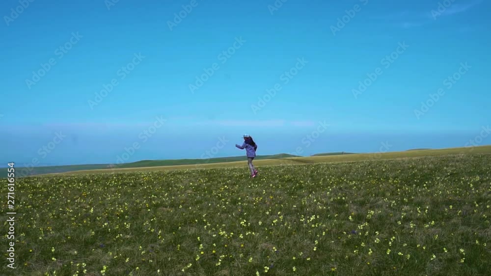 young girl running around the field young girl running around the field