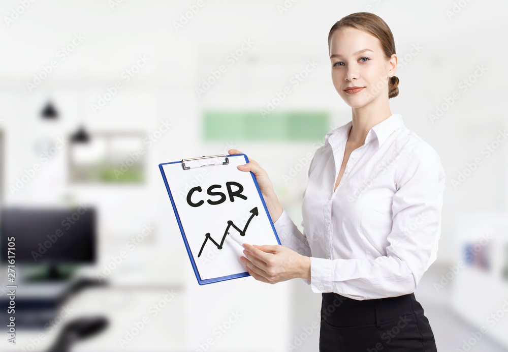 Business, technology, internet and networking concept. Young entrepreneur showing keyword: CSR Business, technology, internet and networking concept. Young entrepreneur showing keyword: CSR