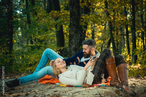 Romantic picnic forest. Couple in love tourists relaxing on picnic blanket. Romantic date in nature. Tourism concept. Couple relaxing in park together. United with nature. Valentines day concept