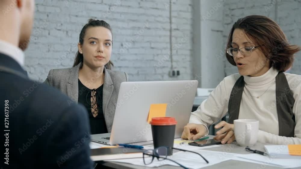 Two woman and man making brainstorming research in office Two woman and man making brainstorming research in office