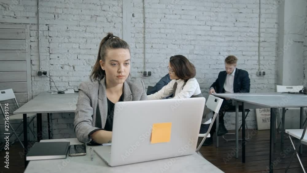 Adult woman using personal computer and sitting in office Adult woman using personal computer and sitting in office
