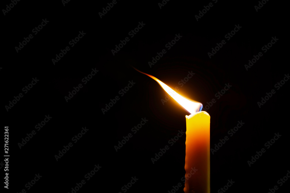 Candle flame in the dark background and space for text. Candle flame in the dark background and space for text.