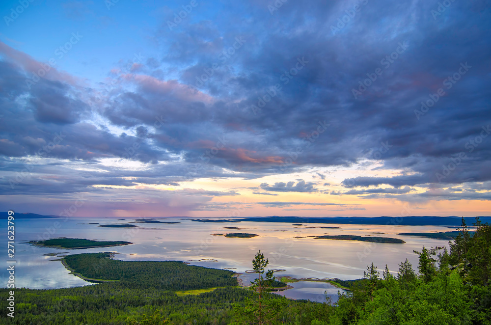 Aerial panorama view of Colorful sunset landscape on the coast of the North Sea. Karelian pine on the rocks on the shore of the White Sea. Coast Murmansk region, Kandalaksha Nature Reserve.