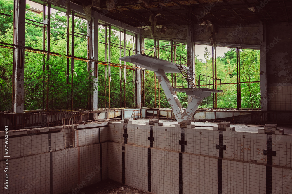 Old empty school swimming pool in destroyed abandoned ghost city Pripyat ruins after Chernobyl Nuclear Power Plant atomic reactor disaster. Exclusion zone, fallout lost town, apocalyptic building. Old empty school swimming pool in destroyed abandoned ghost city Pripyat ruins after Chernobyl Nuclear Power Plant atomic reactor disaster. Exclusion zone, fallout lost town, apocalyptic building.
